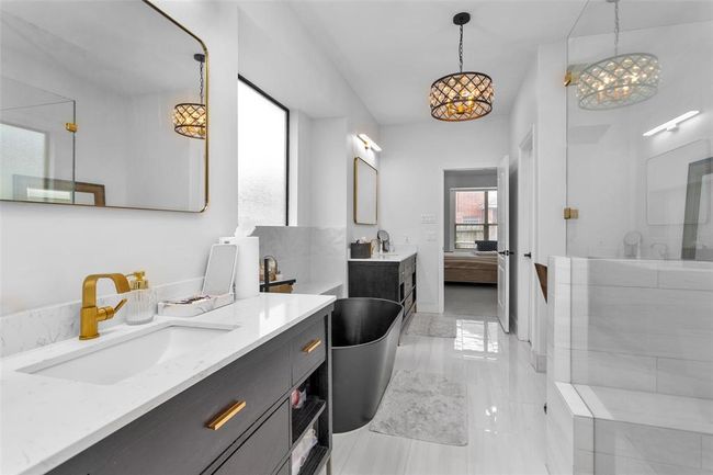 The ensuite bathroom boasts double vanities. | Image 24