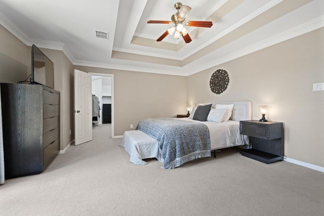 Set at the back of the home and surrounded by trees, the primary bedroom offers a sense of quiet you can feel—soft light, generous space, and direct access to a private balcony | Image 18