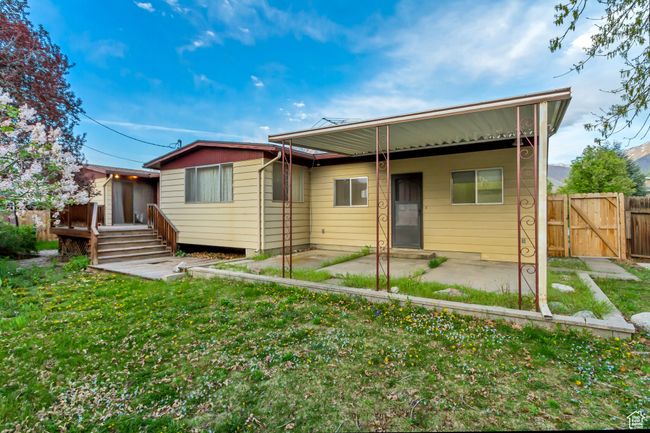 Back of property featuring a gate, fence, a yard, and a patio | Image 28