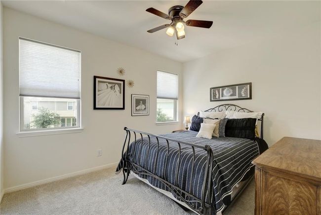 Bedroom with carpet floors, baseboards, and ceiling fan | Image 22
