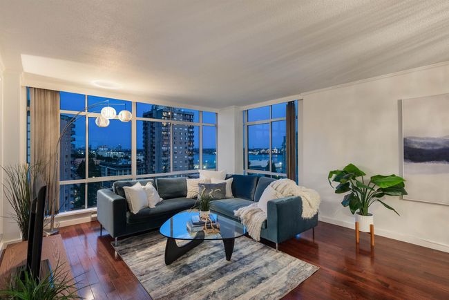Living room with hardwood / wood-style flooring, a view of city, and a textured ceiling | Image 7