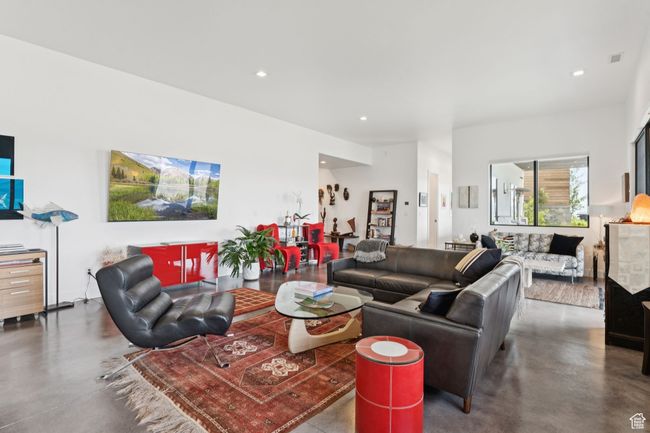 Living room with concrete flooring and recessed lighting | Image 57