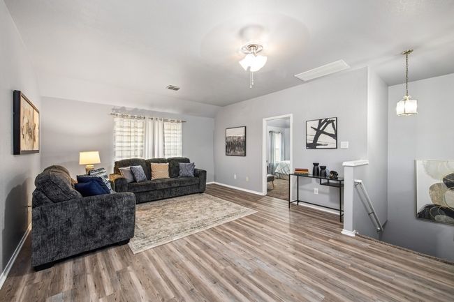 Living room with visible vents, baseboards, a ceiling fan, and wood finished floors | Image 28