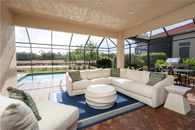 View of patio with outdoor lounge area, an outdoor pool, and glass enclosure | Image 12