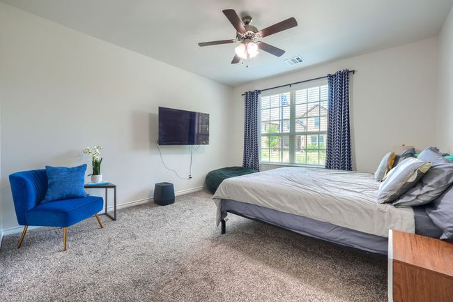 Bedroom featuring carpet floors, baseboards, and a ceiling fan | Image 17