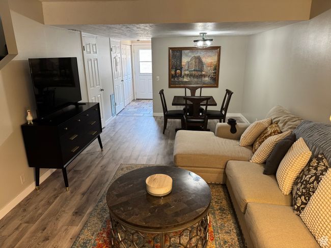 Living room with wood finished floors and baseboards | Image 5