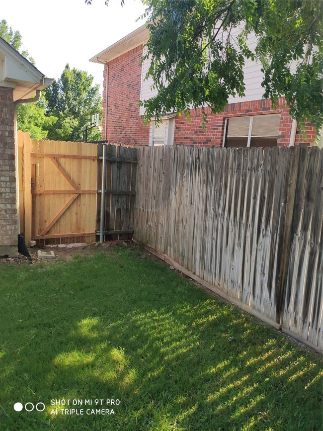 View of yard with a gate | Image 10