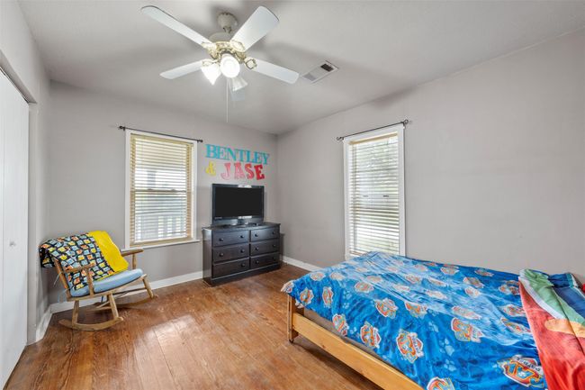 Bedroom featuring baseboards, ceiling fan, visible vents, and wood-type flooring | Image 12