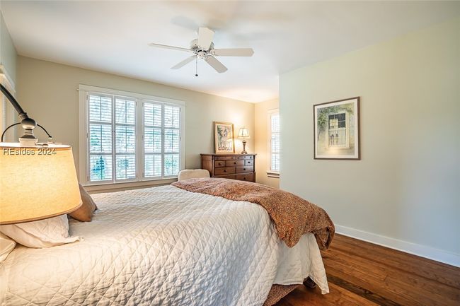 Bedroom featuring dark hardwood / wood-style flooring and ceiling fan | Image 27