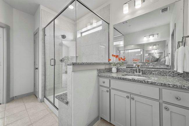 Bathroom featuring tile patterned flooring, vanity, and a shower with shower door | Image 27