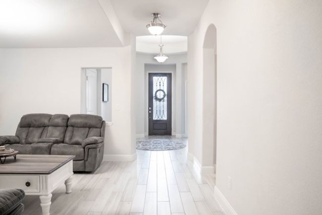 Foyer with arched walkways and baseboards | Image 21