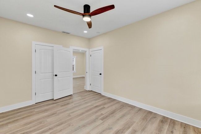 Unfurnished bedroom featuring visible vents, light wood-type flooring, and baseboards | Image 20