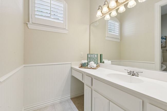 Private vanity area of the jack and jill bathroom features long vanity and generous storage. Shared bathing and toilet space as well as the second private vanity area not pictured. | Image 25