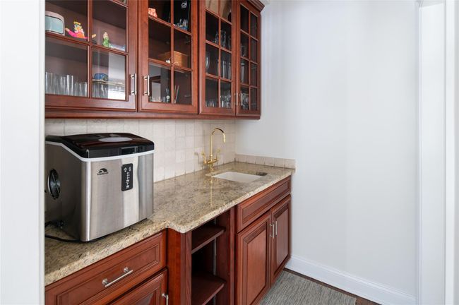 Bar with a sink between great room and formal living room. | Image 16