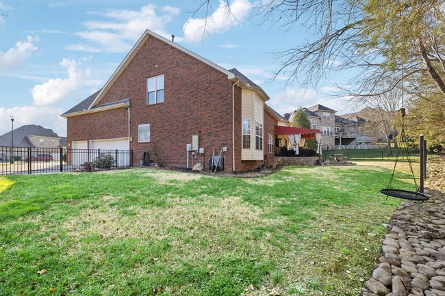 The backyard is fully fenced to safely contain the pets and kiddos. | Image 42