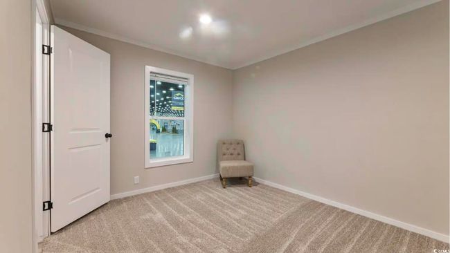 Unfurnished room featuring light colored carpet, baseboards, and crown molding | Image 30