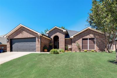 View of front of property featuring a front yard and a garage | Image 1