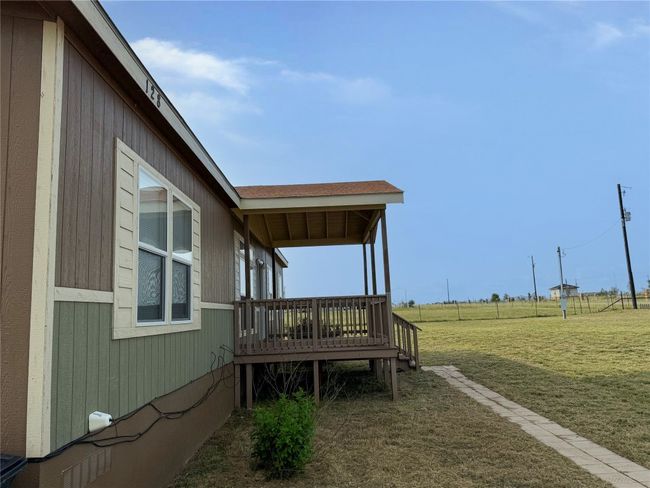 View of green lawn featuring a wooden deck | Image 25