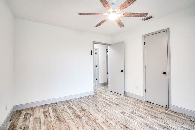 Unfurnished bedroom featuring light wood-style floors, baseboards, and ceiling fan | Image 14