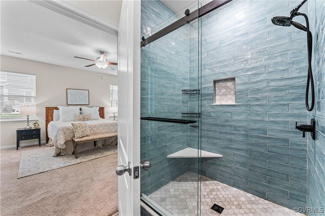 Bathroom with healthy amount of natural light, a stall shower, ceiling fan, crown molding, and ensuite bathroom | Image 35