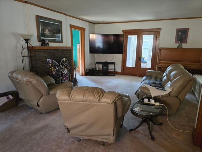 Living room has door to bedroom and French doors to bonus/sunroom & laundry room | Image 8