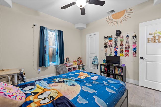 Bedroom with wood finished floors and ceiling fan | Image 29