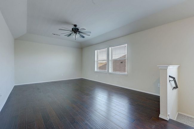 Spare room with ceiling fan, dark wood-style floors, and baseboards | Image 15