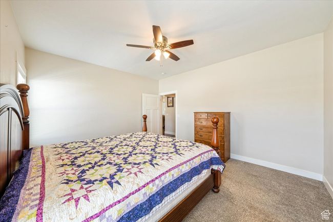 Bedroom with carpet flooring, baseboards, and ceiling fan | Image 23