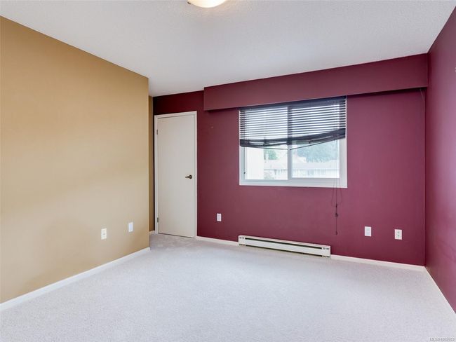 Carpeted empty room featuring a baseboard heating unit and baseboards | Image 12