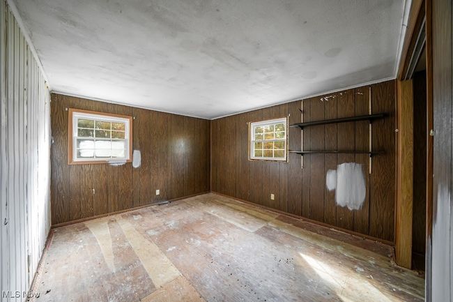 Bedroom with wood walls | Image 5