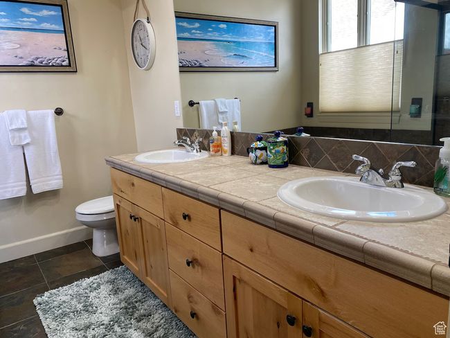 Full bathroom featuring double vanity, tile patterned flooring, a sink, and toilet | Image 12