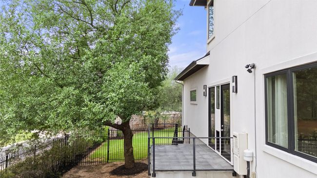 Thoughtfully built with pups in mind, this dog patio with private dog run seamlessly blends with the home’s design. | Image 23