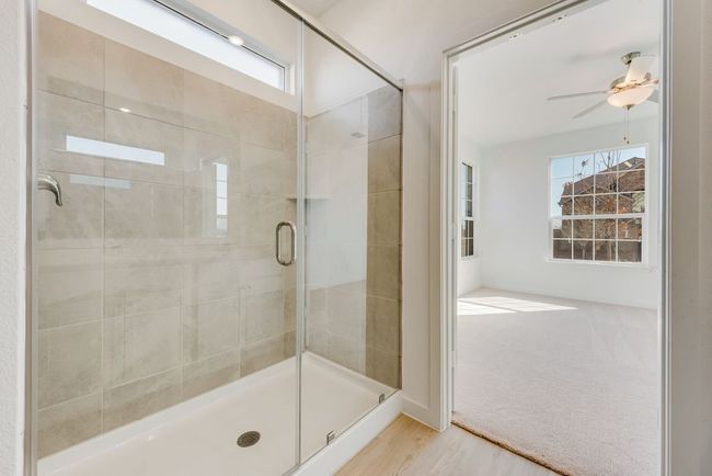 Full bath with a shower stall, wood finished floors, and a ceiling fan | Image 14