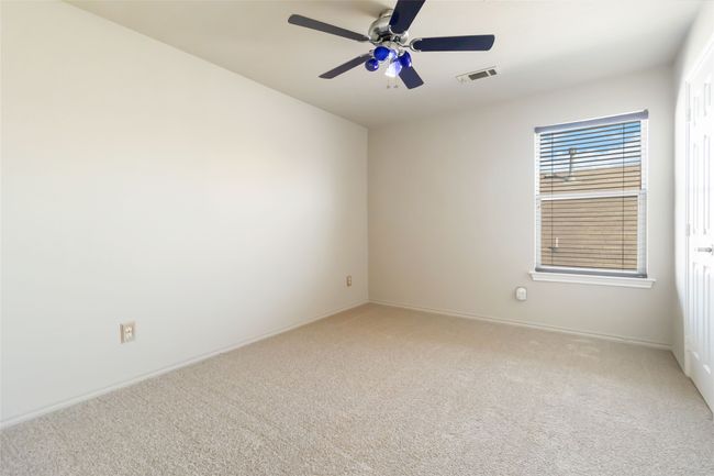 Carpeted spare room featuring visible vents and a ceiling fan | Image 9