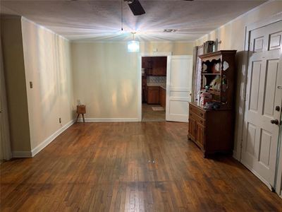 Unfurnished room featuring a textured ceiling, dark hardwood / wood-style flooring, and ceiling fan | Image 2