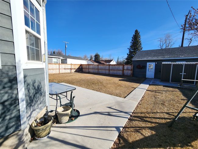 View of yard featuring a patio, an outbuilding, and a fenced backyard | Image 5