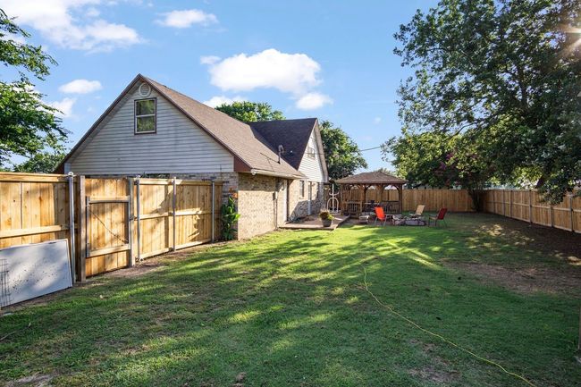 Fenced backyard featuring a gazebo, a gate, and a patio | Image 28