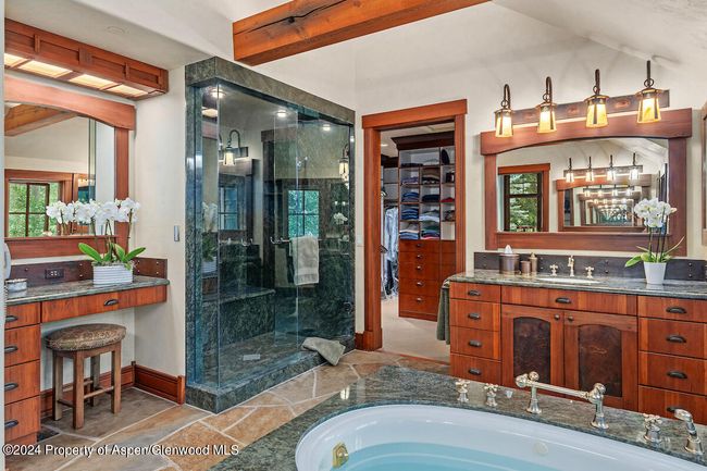 Featuring steam shower for 2, jetted tub, two vanity areas, and dressing table. | Image 32