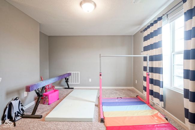 recreation room with carpet floors, baseboards, and a textured ceiling | Image 27