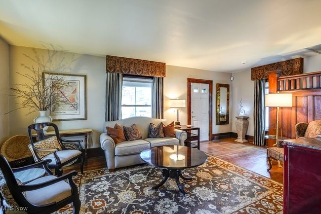 Living area featuring baseboards and wood finished floors | Image 9