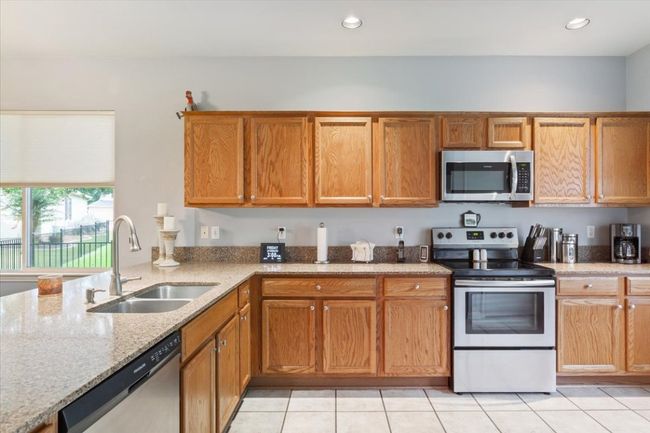 Stainless appliances, granite counter-tops and leveled bar area makes cooking a breeze. | Image 14