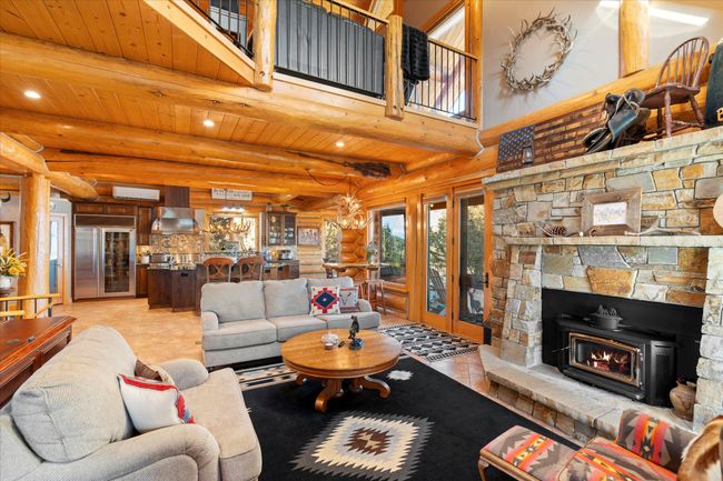 Main level living area. Custom stone fireplace. | Image 41
