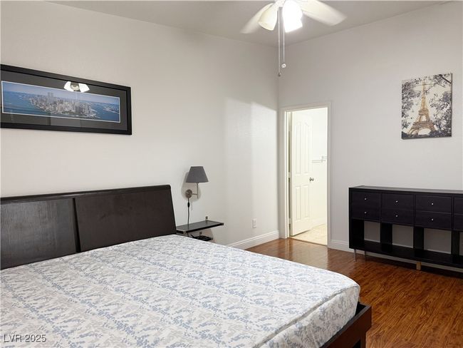 Bedroom with baseboards and wood finished floors | Image 27