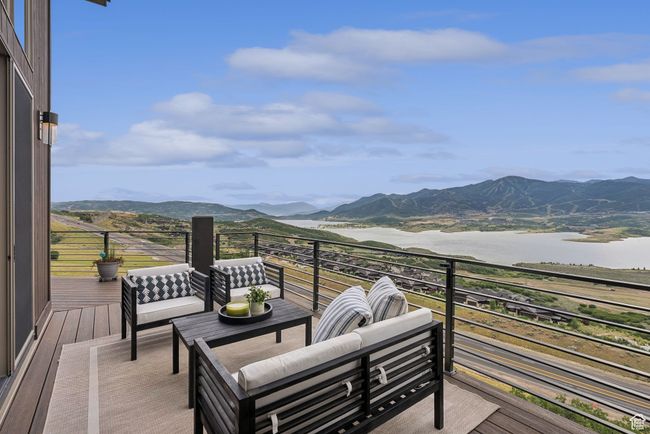 Wooden terrace featuring a water and mountain view and an outdoor living space | Image 57