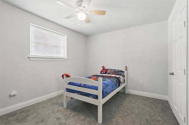 Bedroom with carpet flooring, baseboards, and a ceiling fan | Image 19