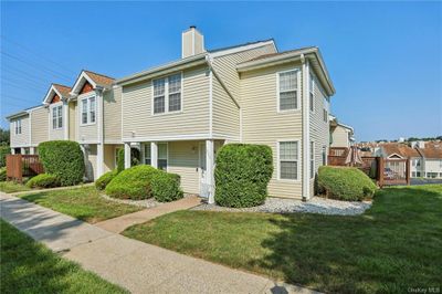 View of front facade with a deck and a front yard | Image 2