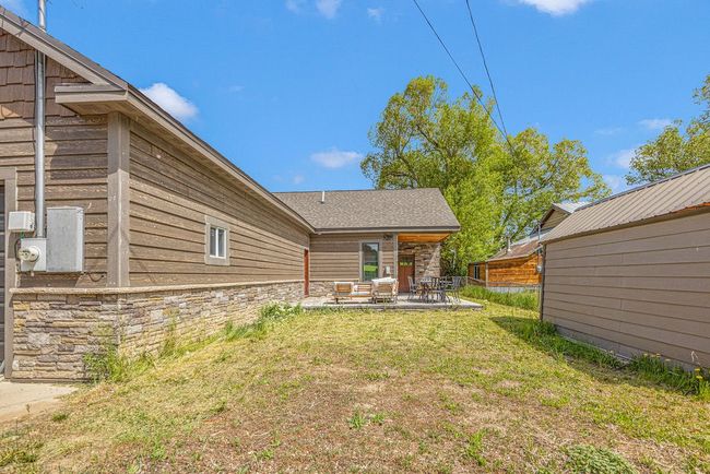 View of grassy yard featuring a patio | Image 7