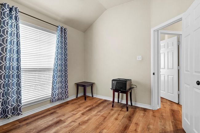 Spare room featuring vaulted ceiling and wood finished floors | Image 31
