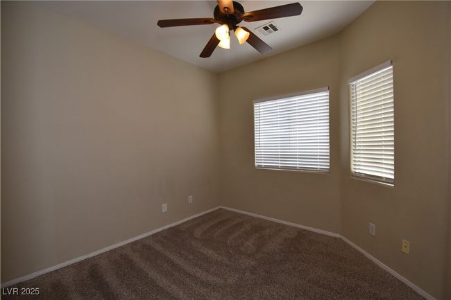 Unfurnished room with carpet, a ceiling fan, visible vents, and plenty of natural light | Image 10