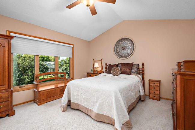 Owners' Suite with vaulted ceiling, walk-in closet and backyard views. | Image 19
